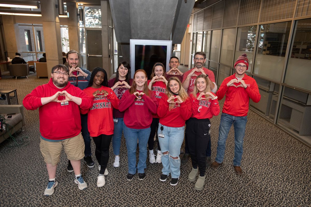 Members of the Owens and Tranter labs at the University of Cincinnati wear red and make hearts with their hands in celebration of “Go Red for Women Day.”