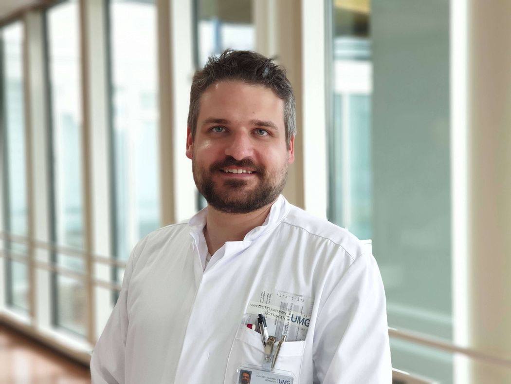 Michael Bartl wears a white lab coat and smiles. Michael Bartl wears a white lab coat and smiles.