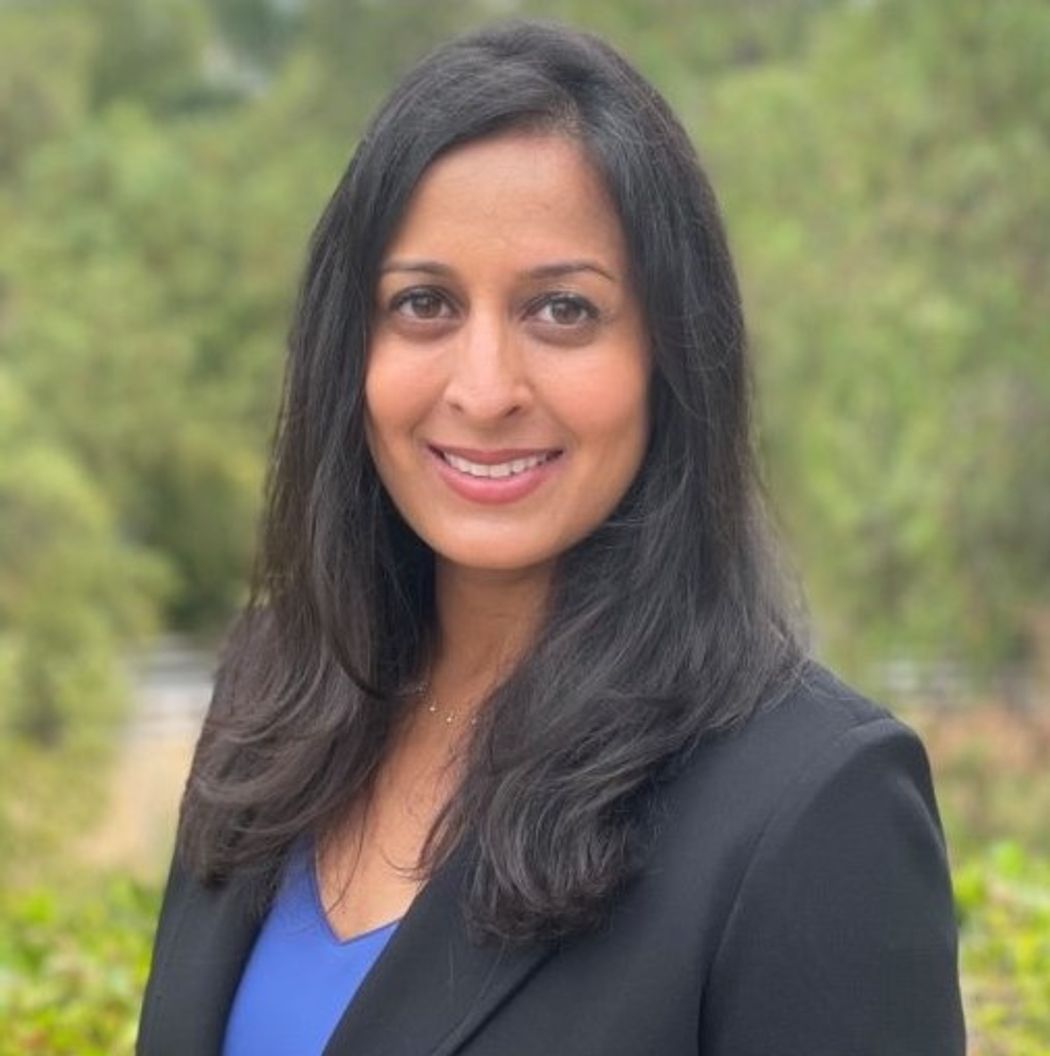 Sumita Bhatta, who is involved in the Sjögren’s disease drug development at Amgen, wears a dark blazer outside against a green background. Sumita Bhatta, who is involved in the Sjögren’s disease drug development at Amgen, wears a dark blazer outside against a green background.