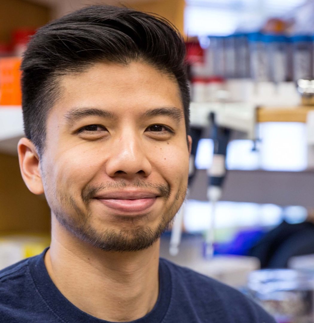 Bryan Hsu stands in a scientific laboratory.