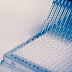 A scientist uses a multichannel pipette to research cells, genetics and DNA