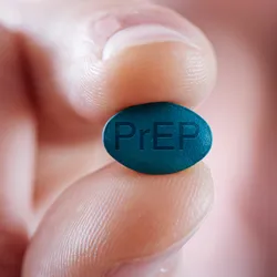 A blurred-out man in the background holds a blue pill that says PrEP in the foreground.