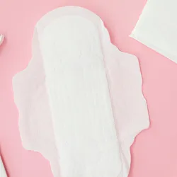 White menstrual pads are shown on a pink background.