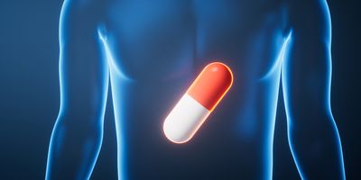 A glowing red and white capsule is superimposed on a translucent blue human figure, centered on the torso.