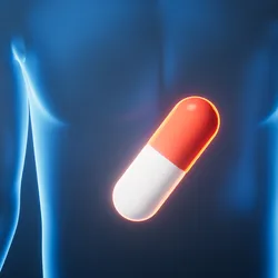  A glowing red and white capsule is superimposed on a translucent blue human figure, centered on the torso.