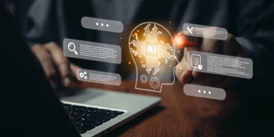 Person using a laptop with a glowing AI brain graphic and floating digital interface icons representing search, settings, tools, and data analysis.