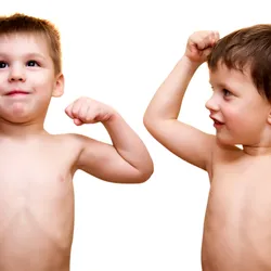 Two little boys show off their muscles 