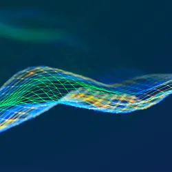 Abstract digital wave made of colorful wireframe mesh lines in blue, green, and yellow on a dark background.