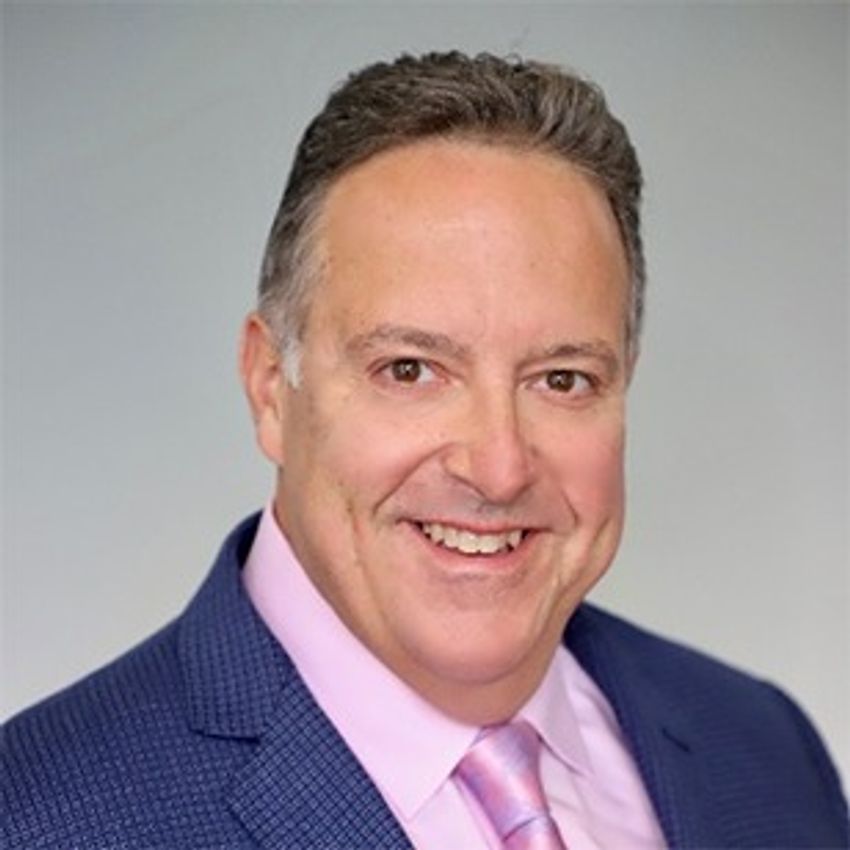 Rob DiCicco smiling in front of plain background