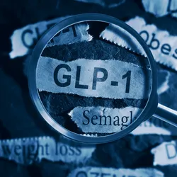 GLP-1 related drugs newspaper headlines with hand and magnifying glass