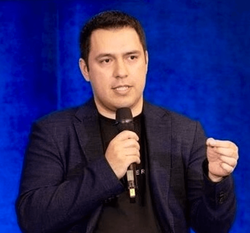 Eric Bennett presenting in front of a blue background