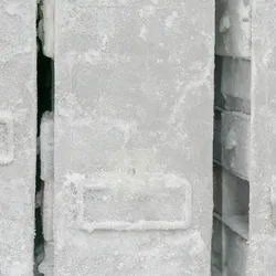 Frozen storage boxes covered in frost inside a laboratory freezer.