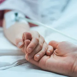 Recovering Child Lying in the Hospital Bed Sleeping, Mother Holds Her Hand Comforting.