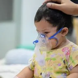 Young patient receiving respiratory therapy with a nebulizer