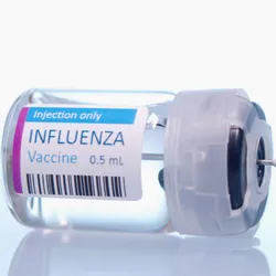 A clear bottle that says influenza vaccine with a syringe.