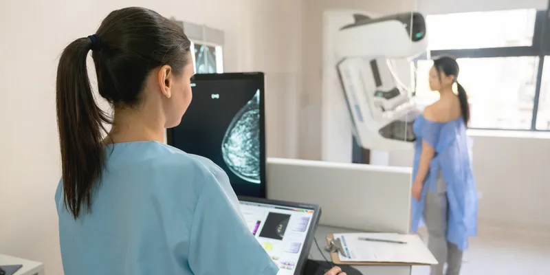 Nurse taking a mammogram exam for an adult patient at the hospital