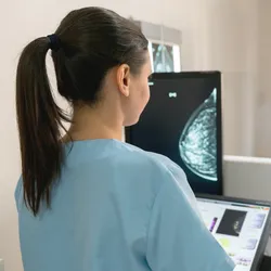 Nurse taking a mammogram exam for an adult patient at the hospital