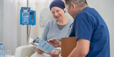 A male nurse of Asian decent, makes his way around to cancer patients as he check in on them during their Chemotherapy treatments.