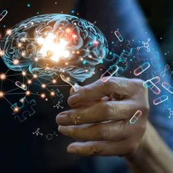 A transparent human brain is shown with a lit up puzzle piece in the middle and floating pills around it.