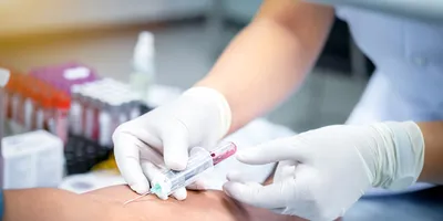 Taking a blood sample from a patient in the hospital.