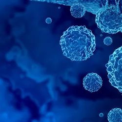 Malignant cancer cells are shown as a blue cluster of cells is against a dark blue background.   