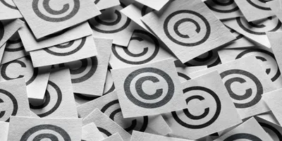 A bunch of copyright symbols printed on paper in a pile