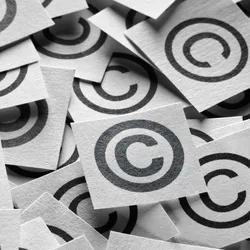 A bunch of copyright symbols printed on paper in a pile