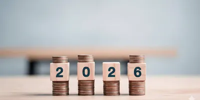 2026 stacked coins and wooden blocks
