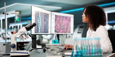 Researcher looking at DNA on her computer