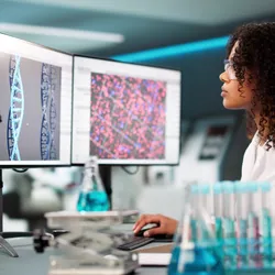 Researcher looking at DNA on her computer 