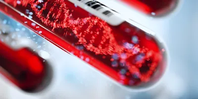 Molecule of DNA forming inside a test tube full of blood. 