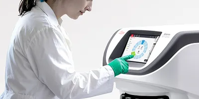 A female scientist using the Aperio GT Elite Scanner