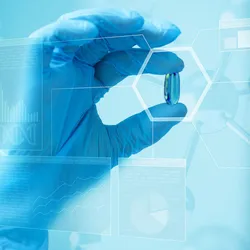 scientist holding a pill behind a scientific blue screen