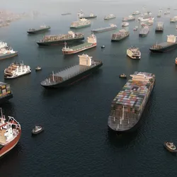 Cargo vessels congestion blocking maritime traffic in the Strait of Hormuz, tankers and container cargo ships clustered in aerial 3D illustration render. 