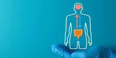 Doctor's hand holding a Gut-Brain Axis icon, symbolizing the link between the digestive system and the brain.
