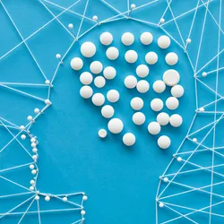 Pins and threads in the shape of a human head, with pills indicating the brain. 