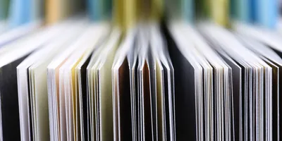 A close-up of the edges of papers next to each other.