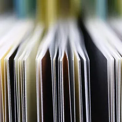 A close-up of the edges of papers next to each other.