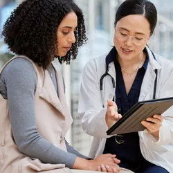 Doctor consults clinical trial patient. 