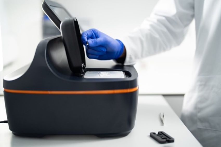 A scientist setting up a MyMass mass photometer measurement.