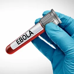 A photo of a gloved blue hand holding a vial of blood labelled Ebola.