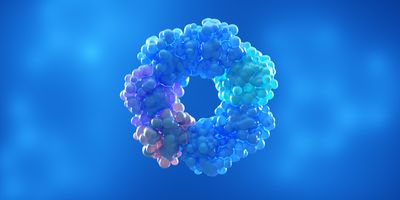 3D illustration of a protein complex composed of clustered spherical subunits arranged in a ring-like oligomeric structure, shown in shades of blue, cyan, and purple against a blue gradient background.