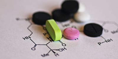 pills of various colors laid on a paper