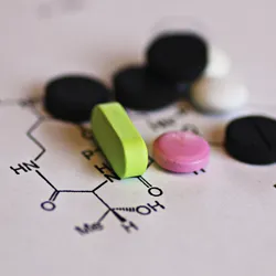 pills of various colors laid on a paper