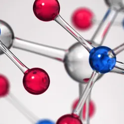 A 3D molecular model showing interconnected red, blue, and silver atoms against a gray background. 
