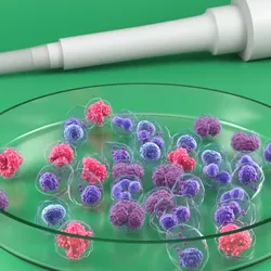 A pipette tip positioned above a petri dish containing colorful 3D cell cultures.