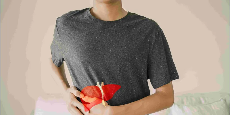 A man in a gray shirt with a red liver overlaid