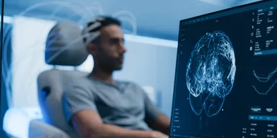 Patient connected to brain scan. 