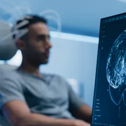 Patient connected to brain scan. 