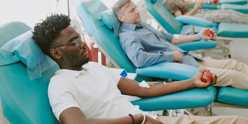 Three people getting blood transfusions at the hospital.